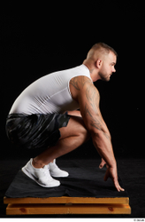 Whole Body Man White Sports Shorts Muscular Kneeling Top Studio photo references